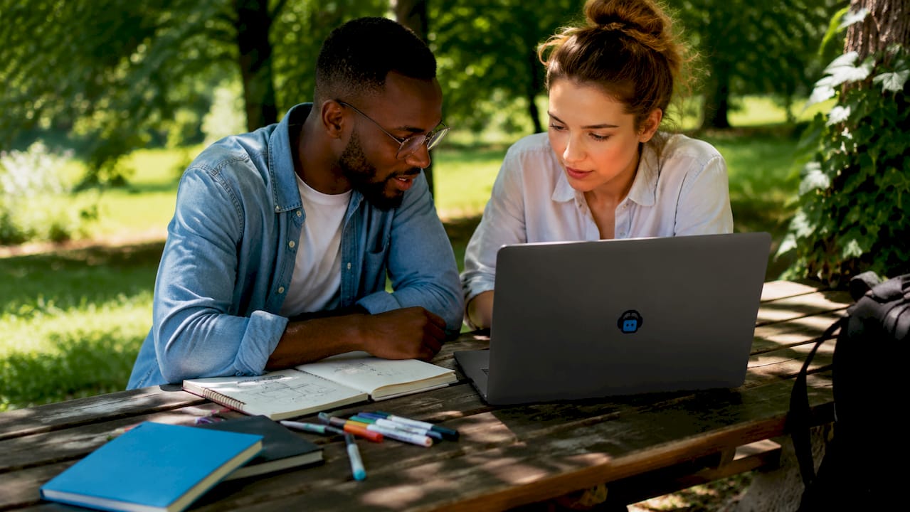 two developers collaborating at laptop