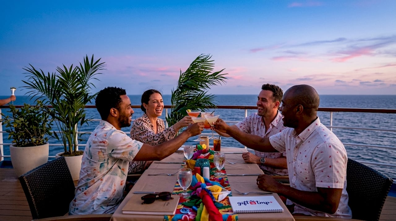 why choose group travel incentives for your team in 2026 3 team toasting on cruise ship deck at sunset