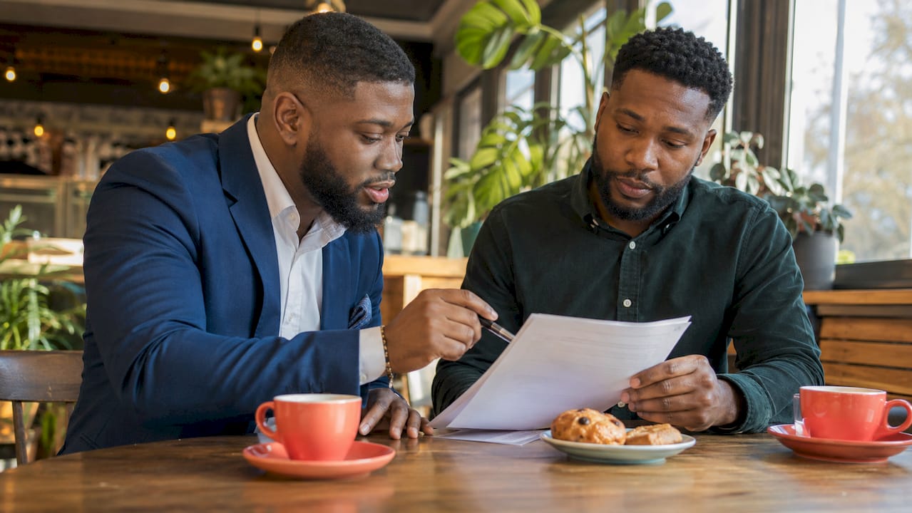 Two men discussing insurance riders