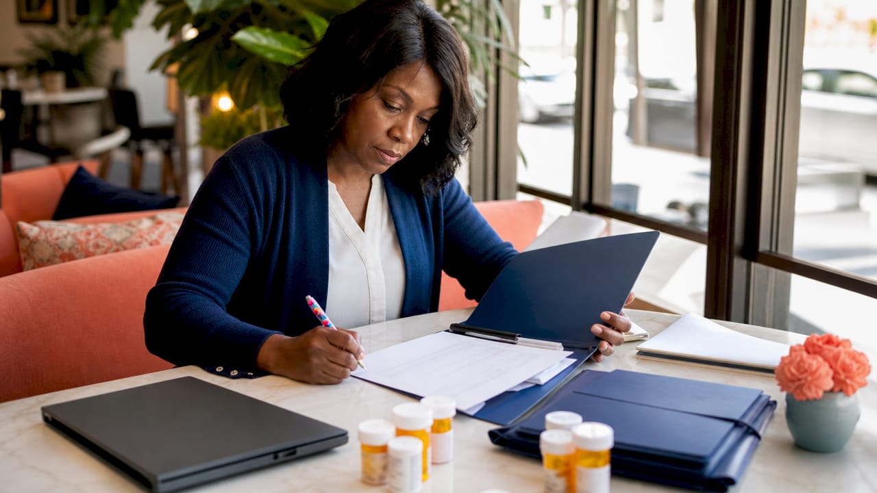 Hands organizing life insurance application documents