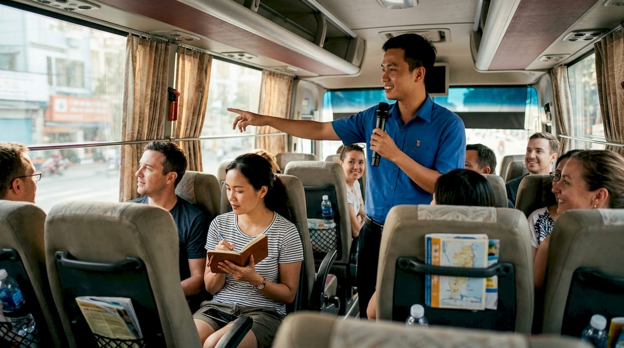 Tour guide explaining Vietnam sights on coach