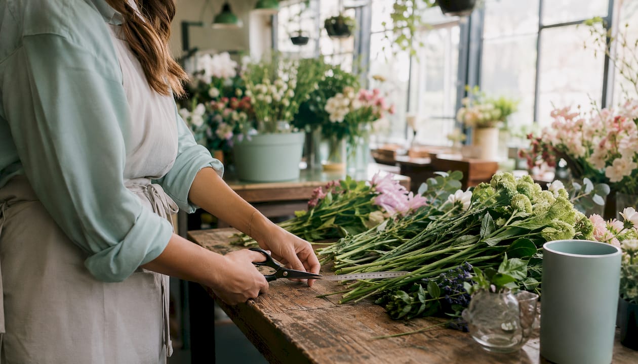 Florist hands grading flower stems closely