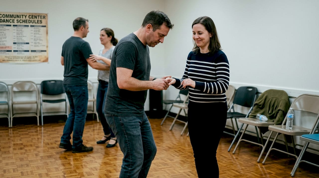 Salsa partners practicing steps in community hall