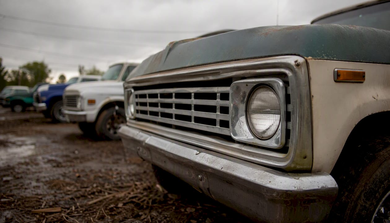 Partial close-up of classic pickup truck front at sales lot