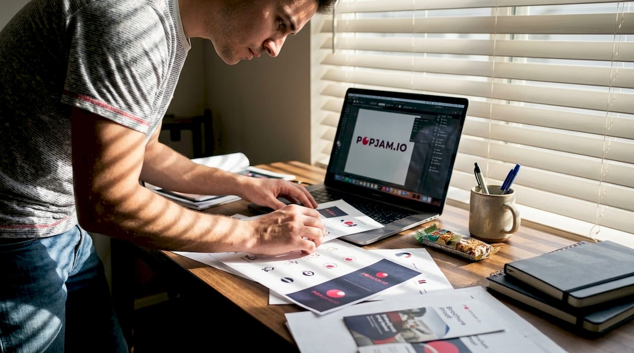 Designer sorting brand assets at home desk