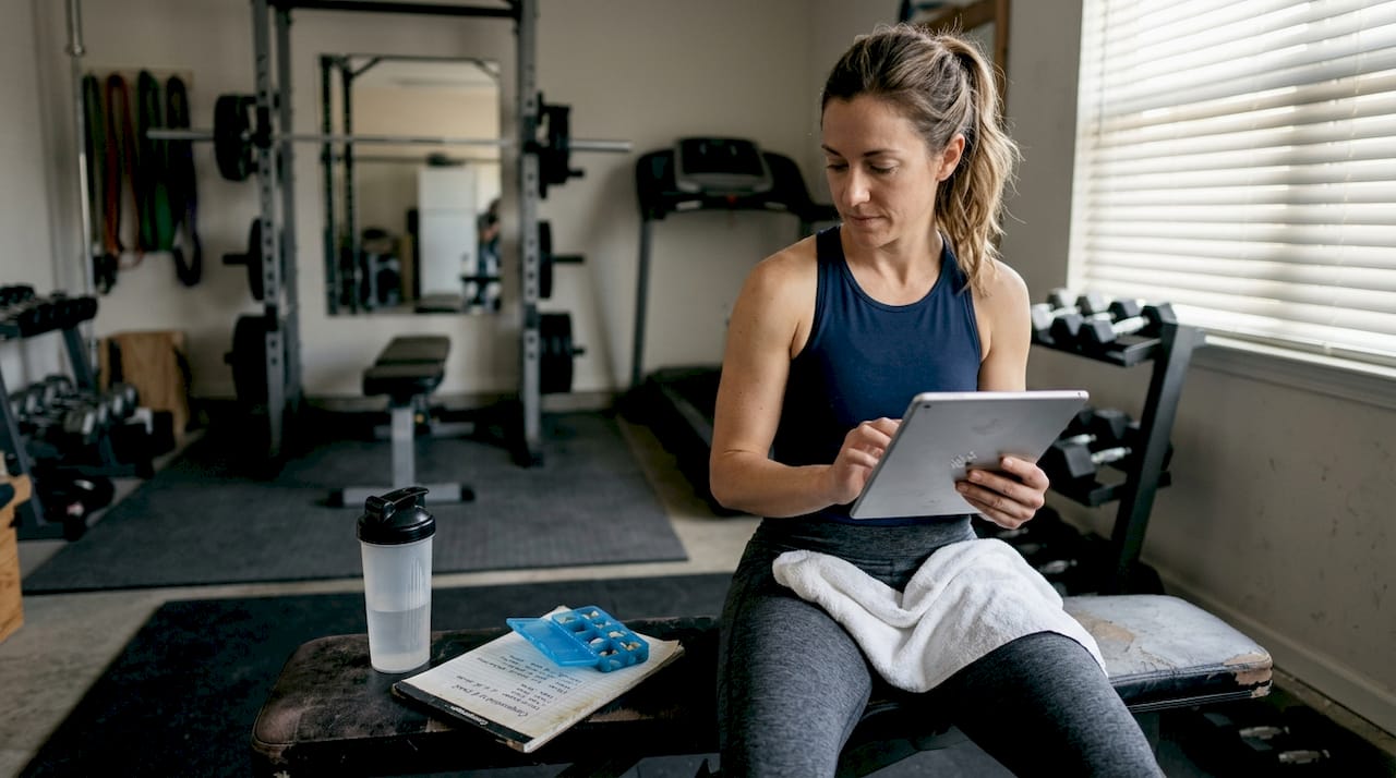 Athlete reviews peptide options in home gym