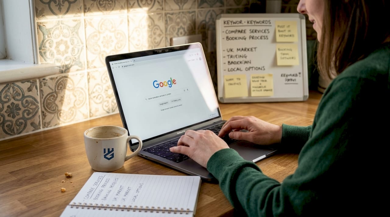 Woman researching local keywords on laptop