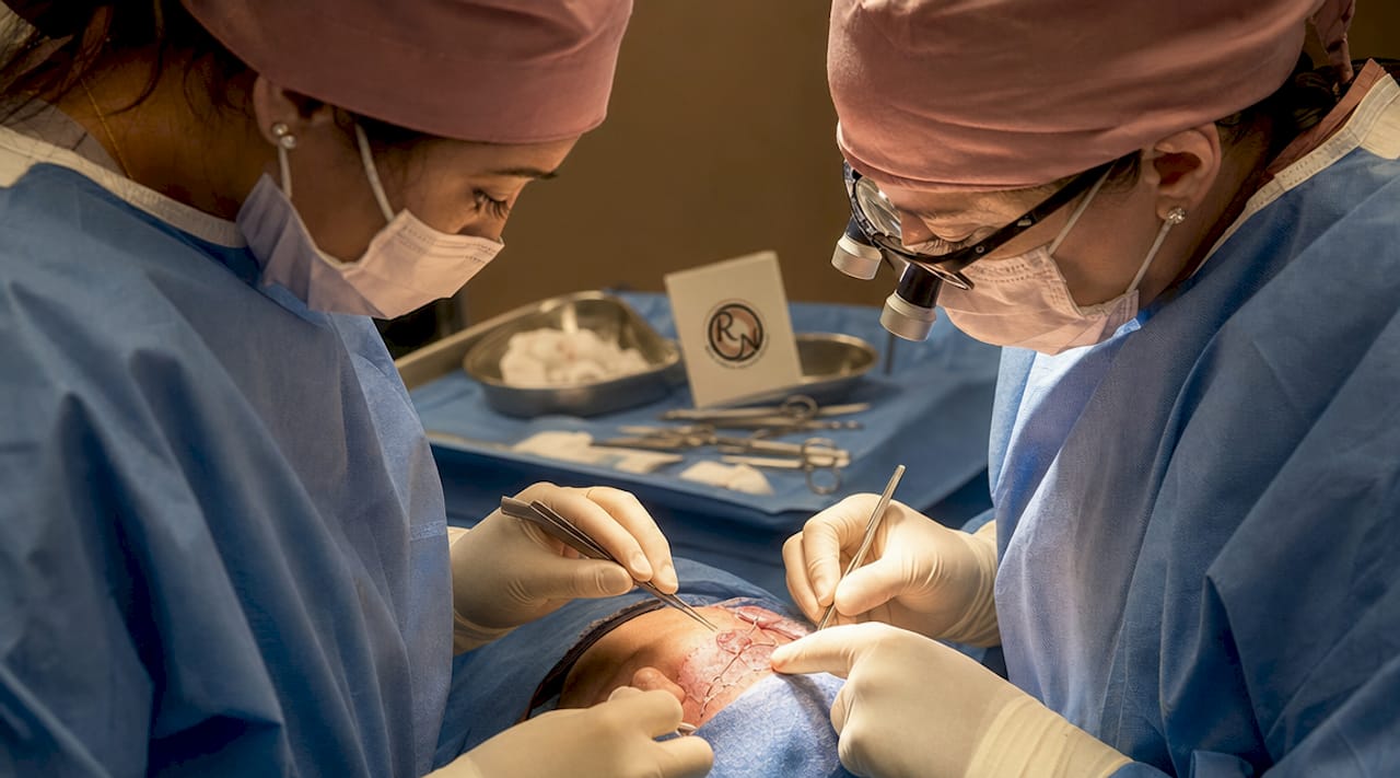Surgeons performing reconstructive skin surgery