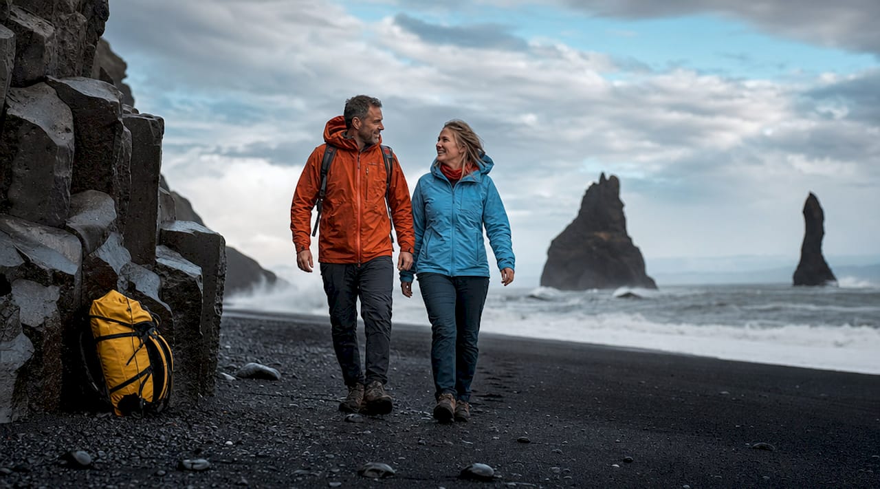 Couple walking on Reynisfjara black sand beach