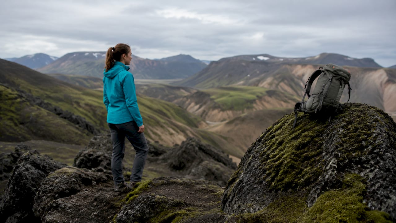 Hiker appreciating colorful Icelandic mountains