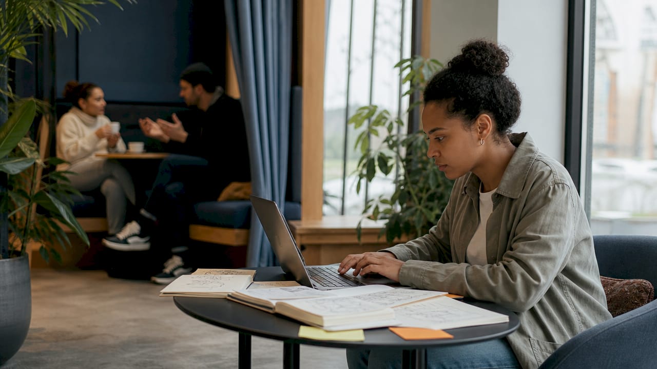 Woman working in coworking space at shared table