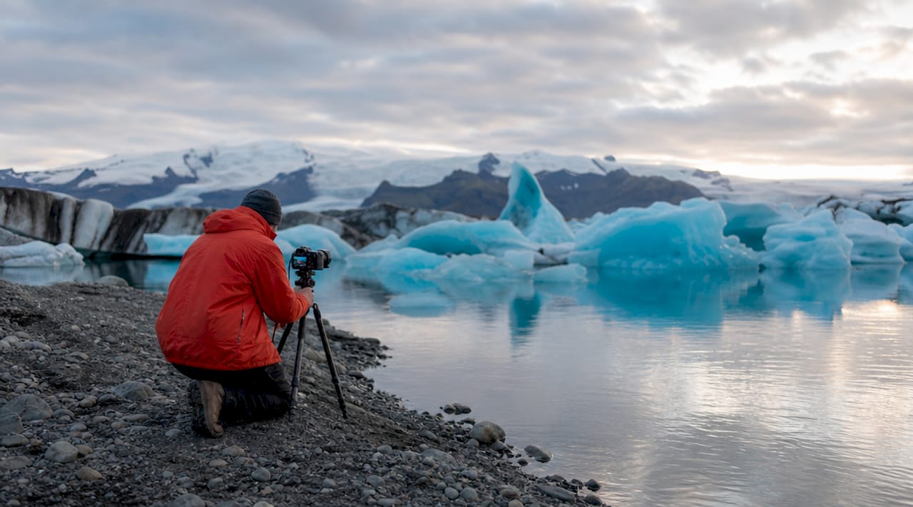 Photographer capturing Jökulsárlón glacier lagoon sunrise