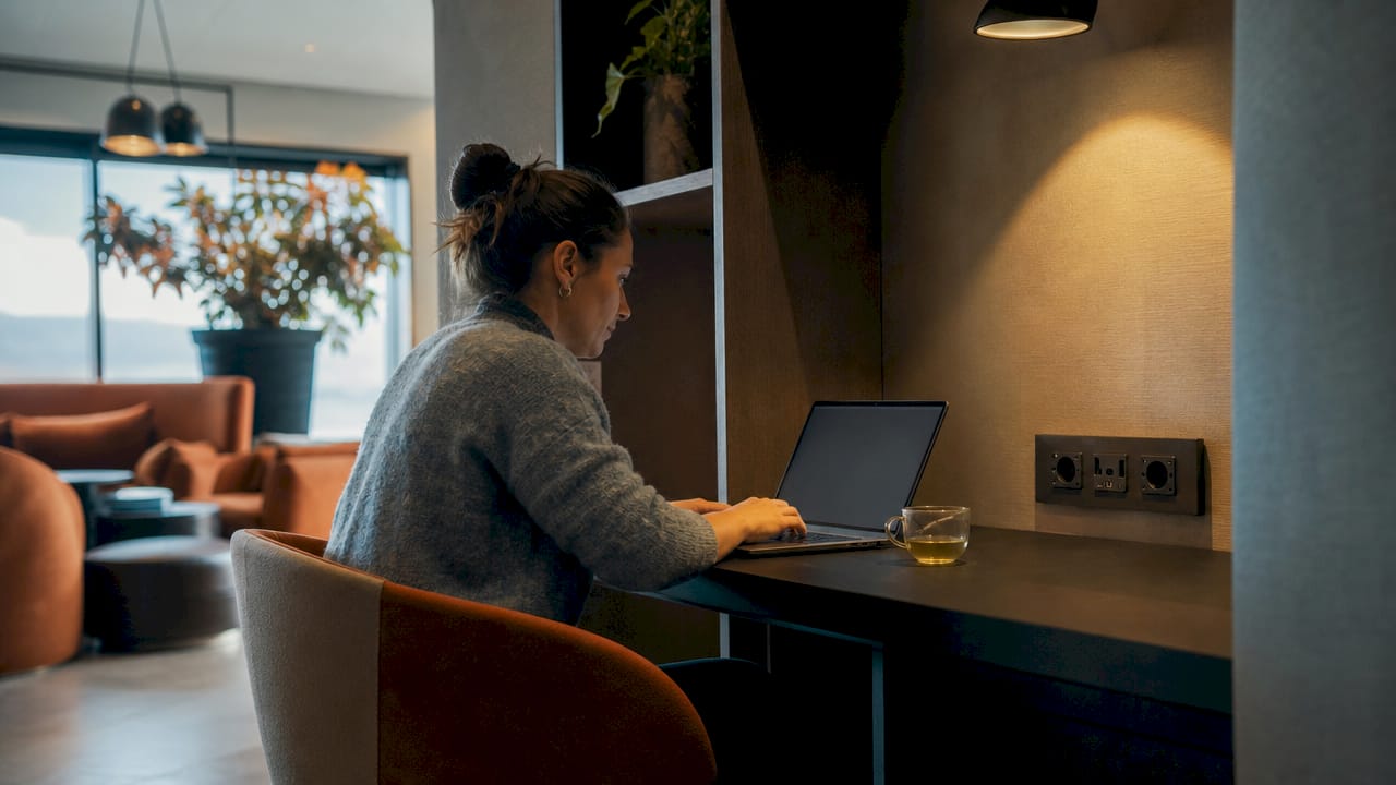 Traveler working in hotel guest lounge