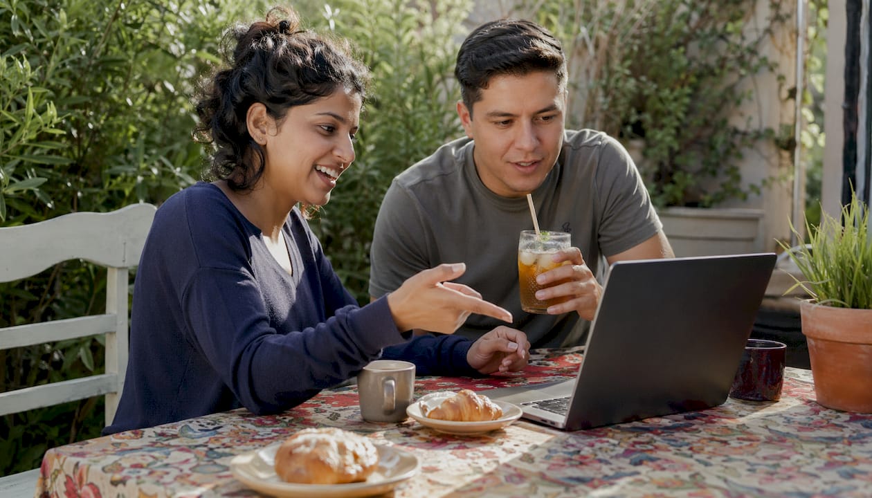 Couple discussing Iceland travel bookings at cafe