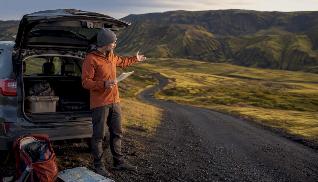 Solo traveler preparing rental car in Iceland