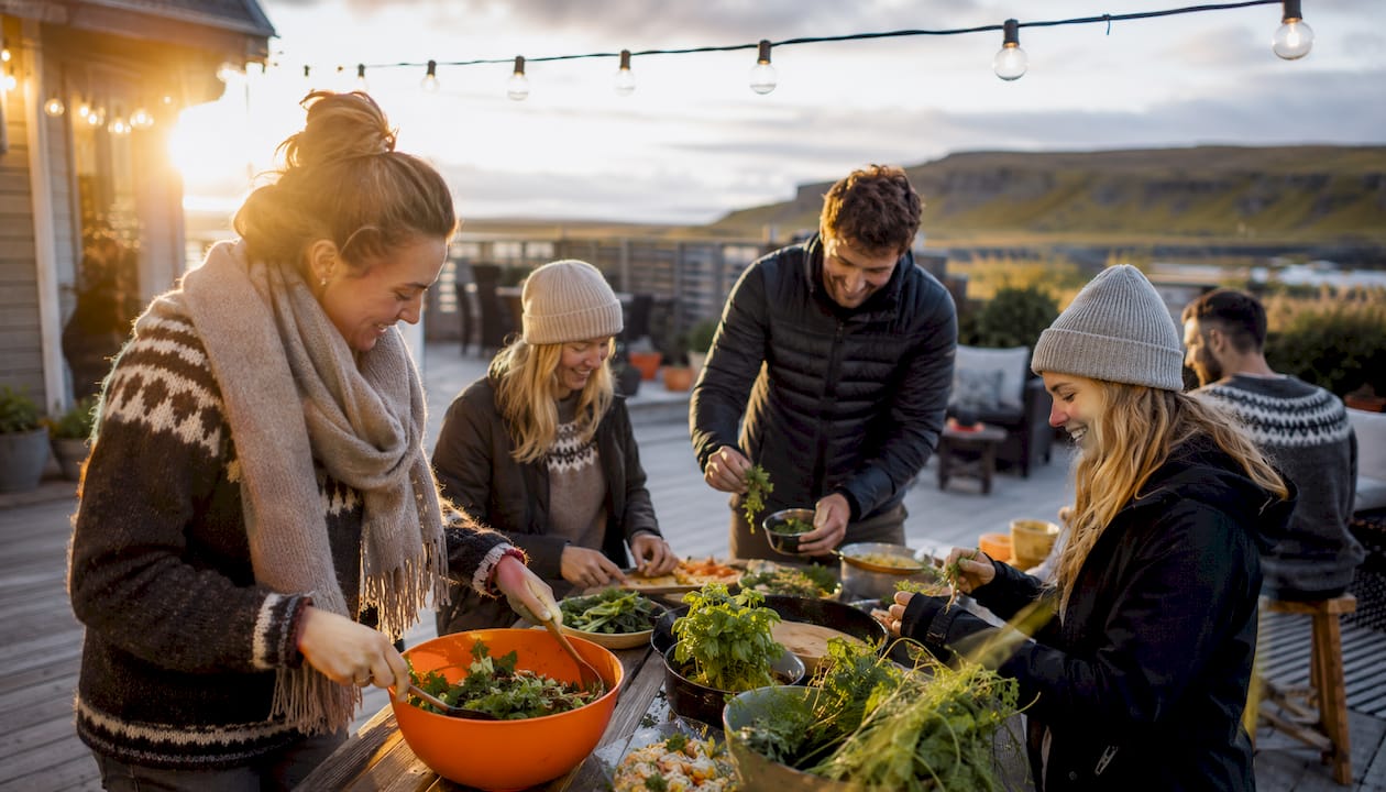 Solo travelers cooking in Iceland hostel kitchen