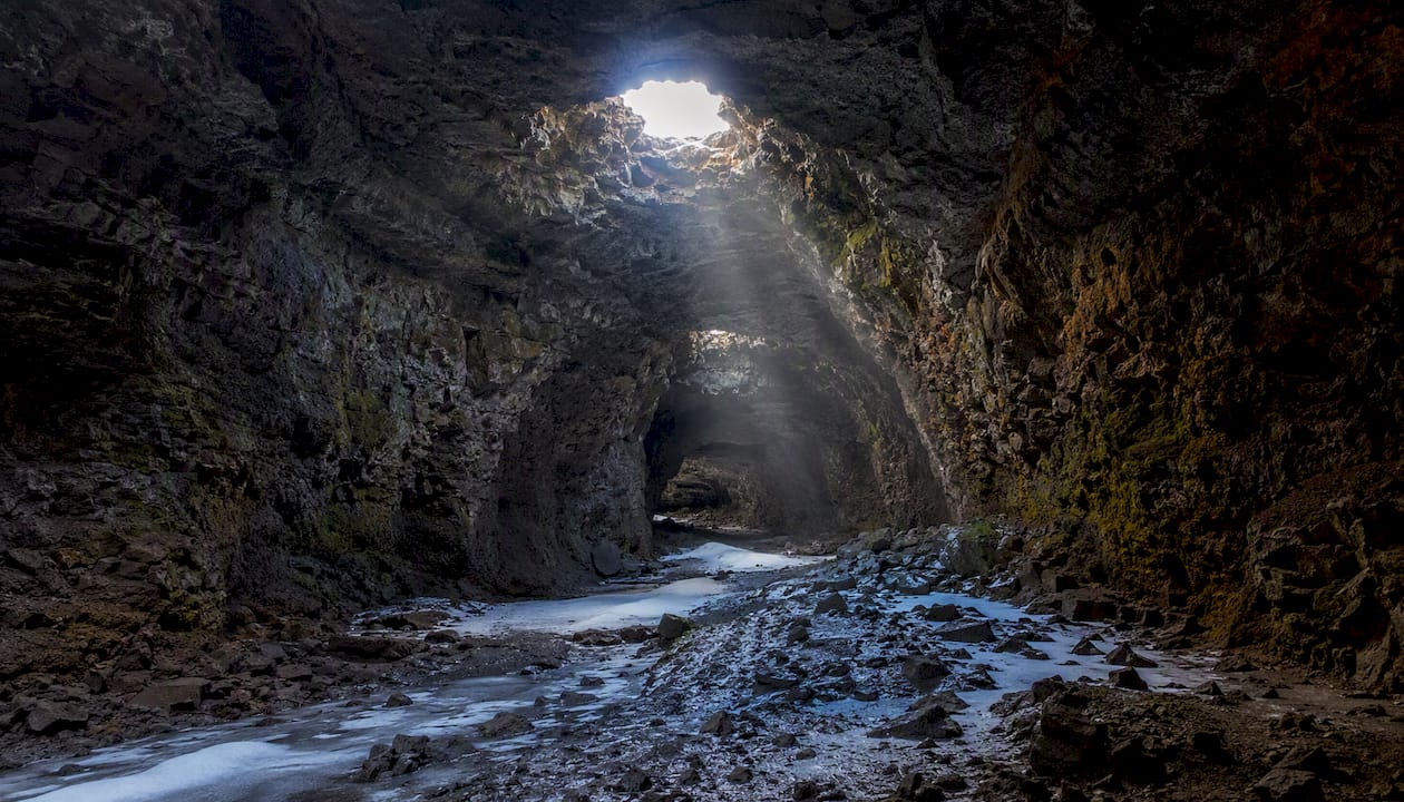 Interior view of Raufarhólshellir lava tube with light shafts