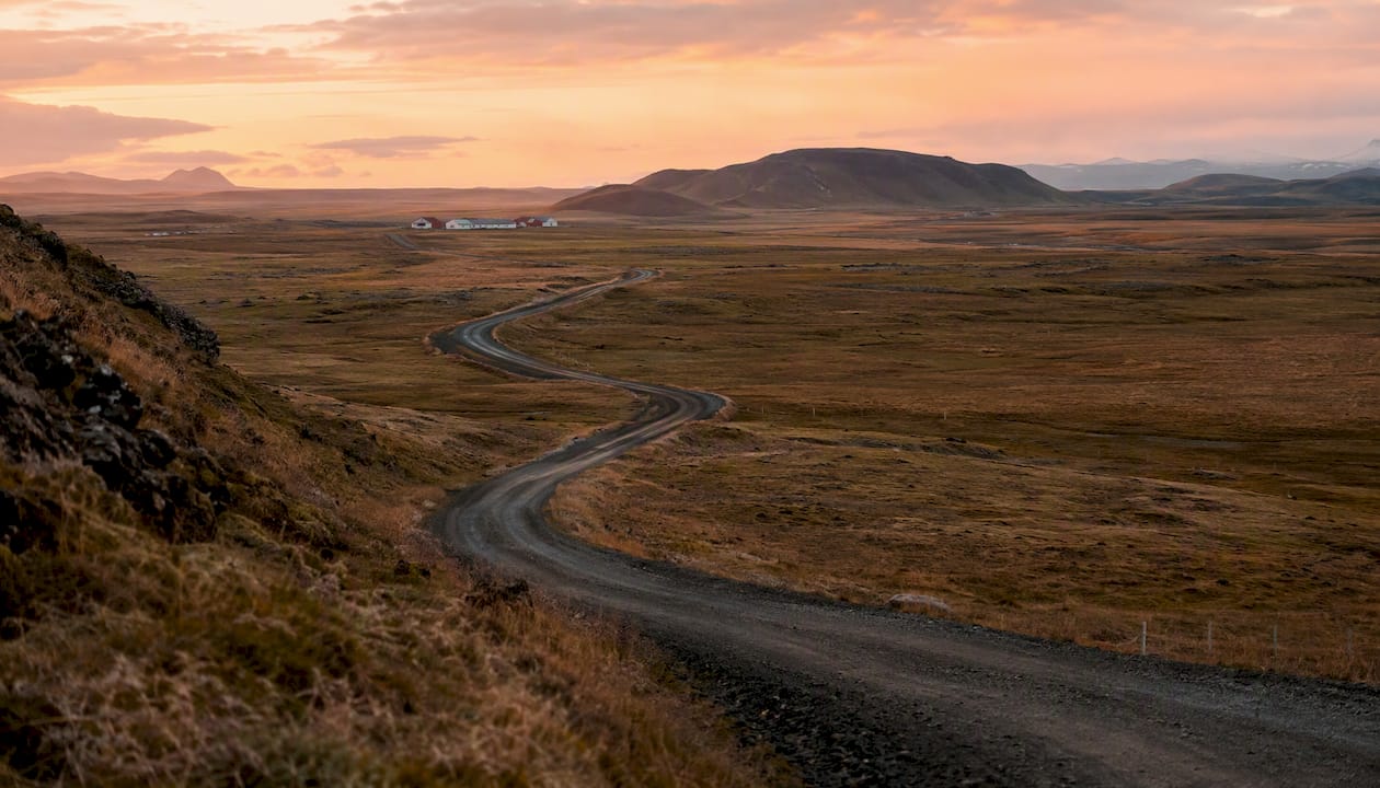 Winding gravel road in Icelandic countryside morning