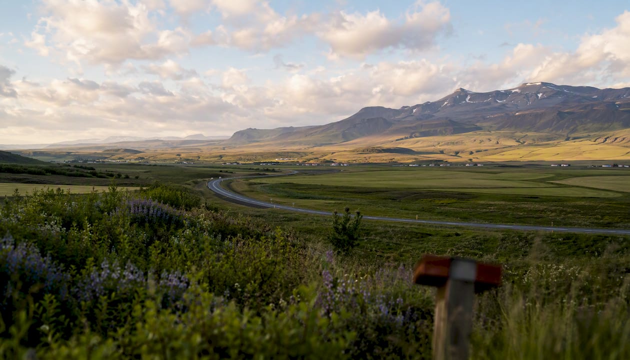 South Coast road leading to Hvolsvöllur with volcanic backdrop