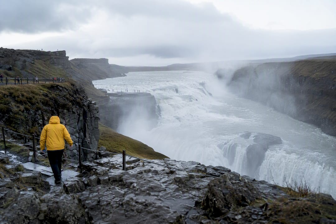 Visitors near mist of Gullfoss waterfall
