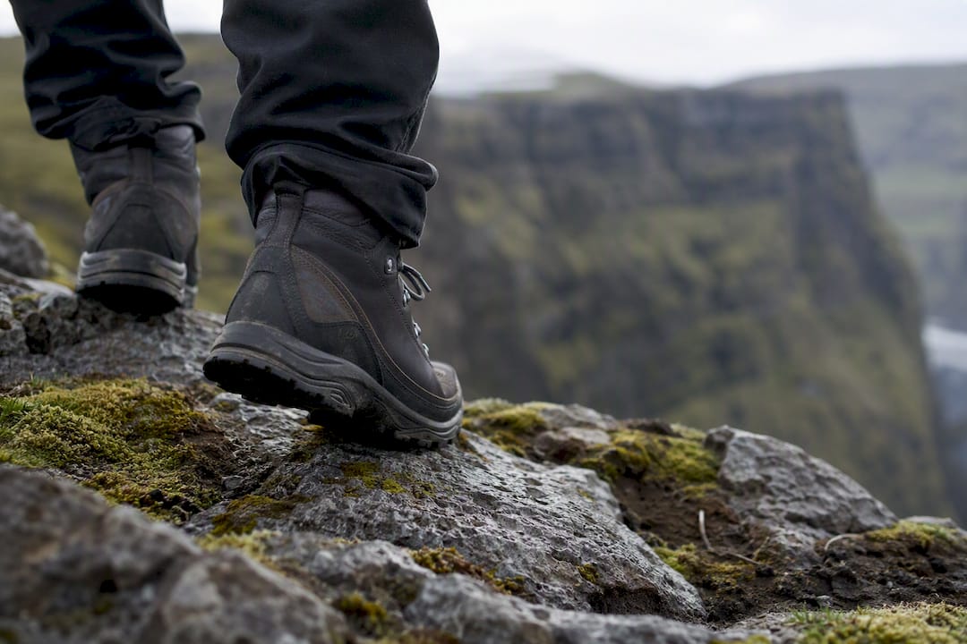Close-up of hiking boots on gravel trail