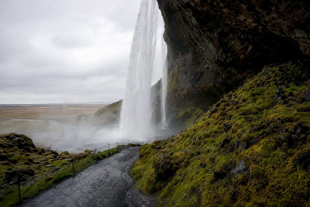 Seljalandsfoss waterfall behind water curtain view