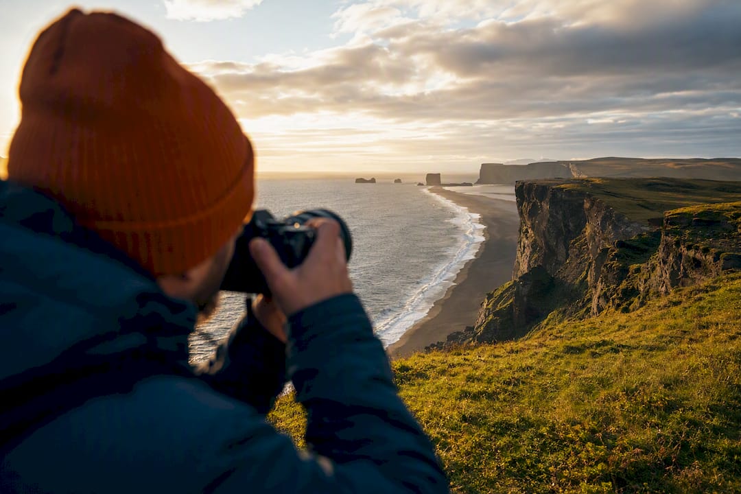 Photographer overlooking Dyrhólaey at summer twilight