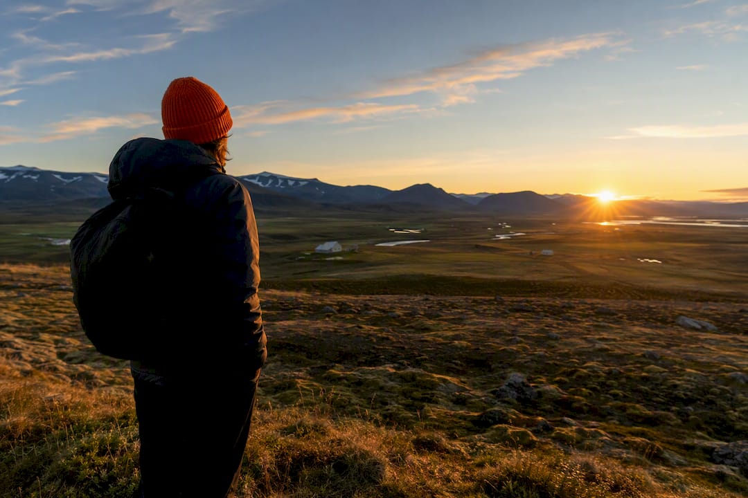 Traveler watching Iceland's midnight sun