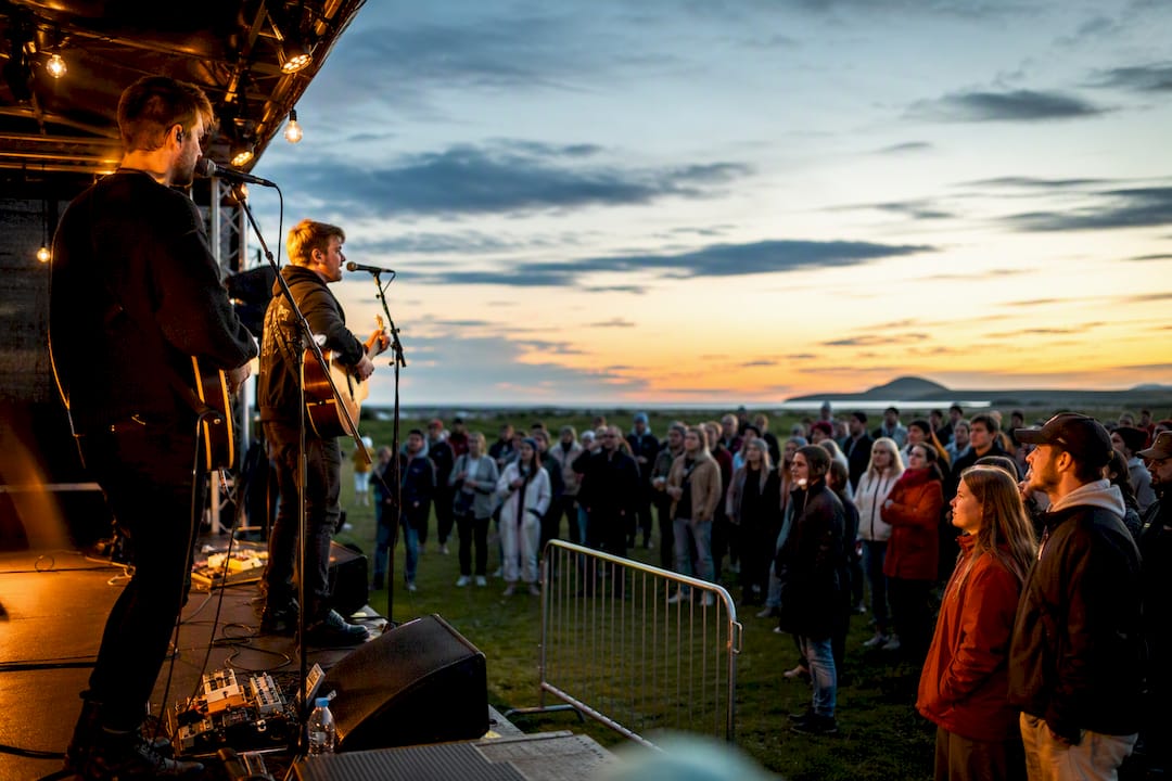 Outdoor concert beneath Iceland's bright night sky