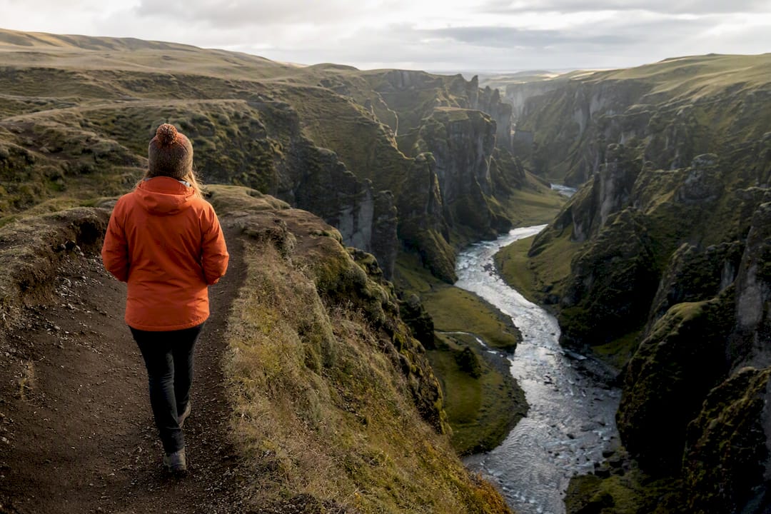 Visitor viewing mossy Fjaðrárgljúfur gorge