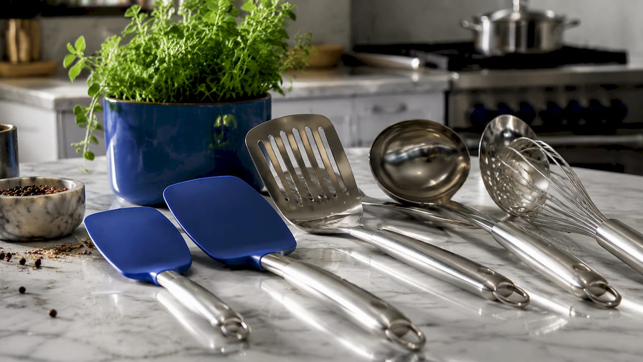 Close-up of stainless steel kitchen tools on cutting board
