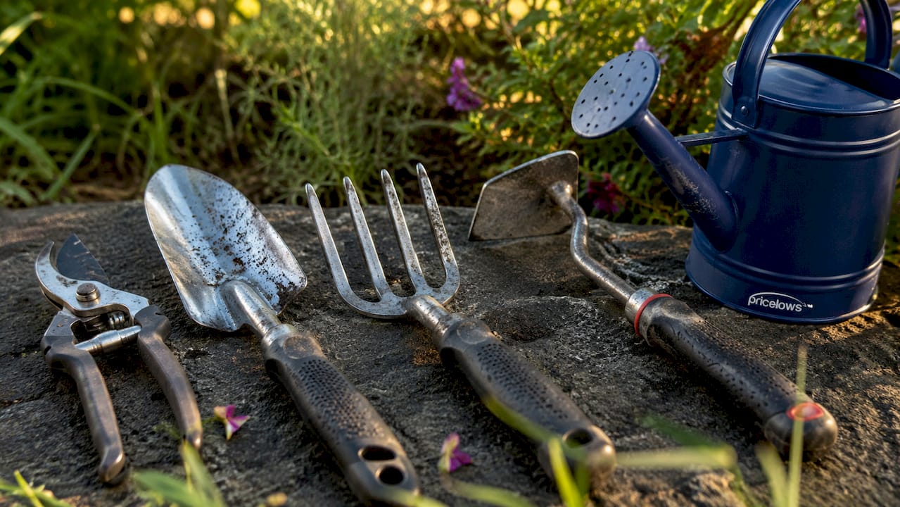 Close-up of essential budget hand yard tools with logo