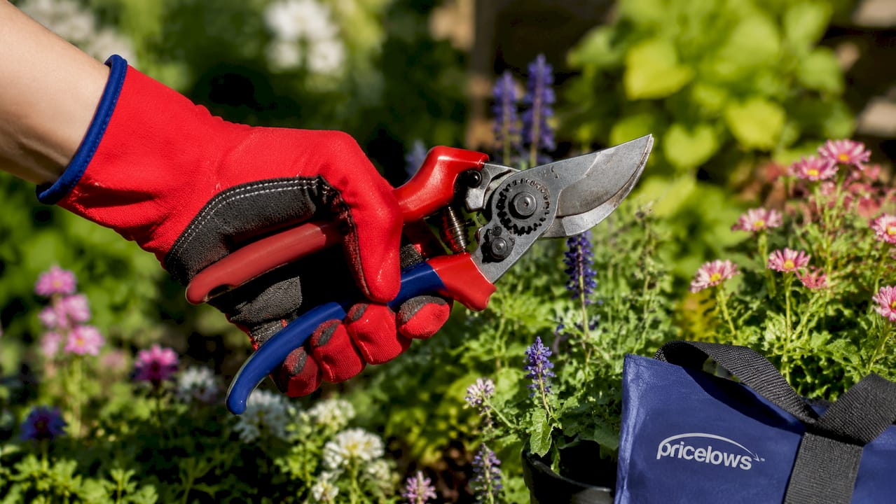Close-up of hand gripping ergonomic ratchet pruner