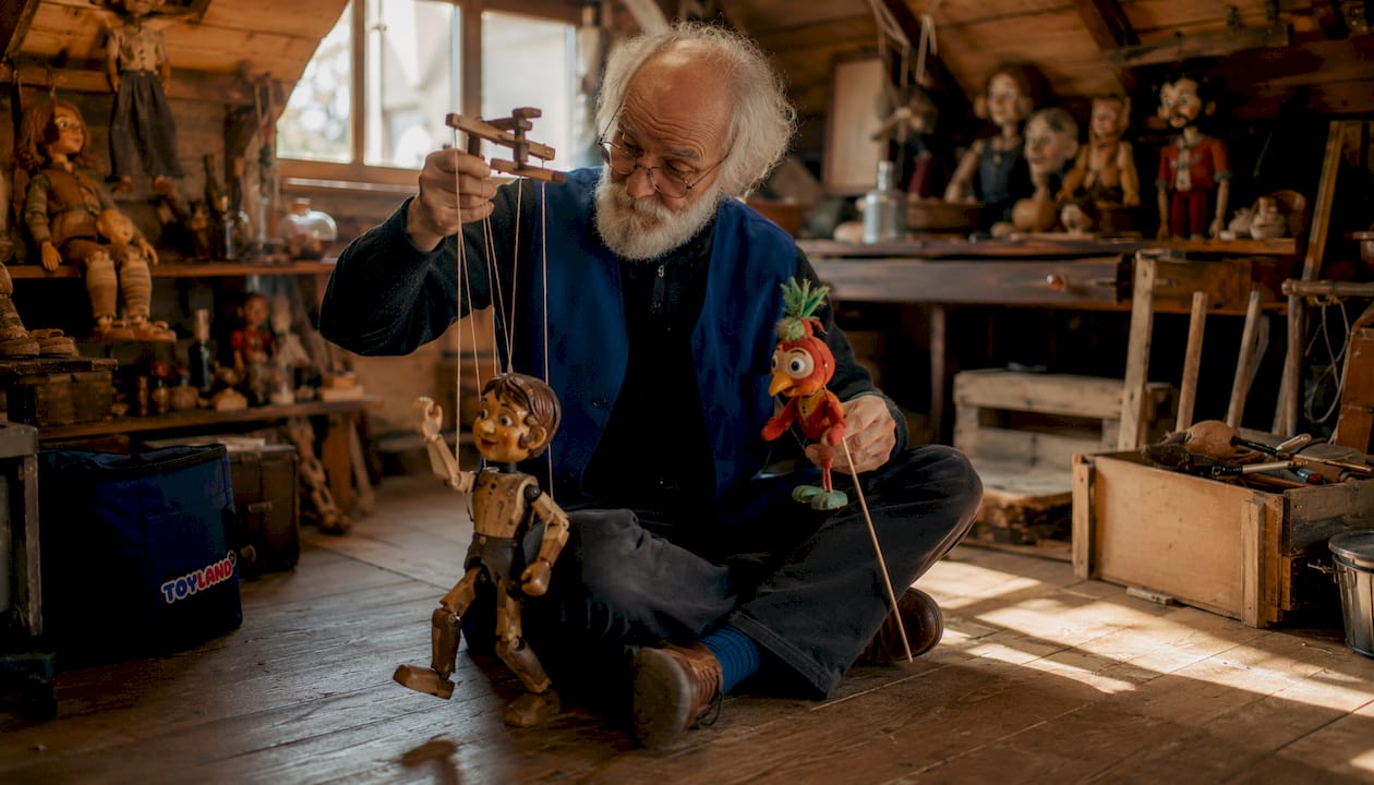Hands manipulating rod and marionette puppets
