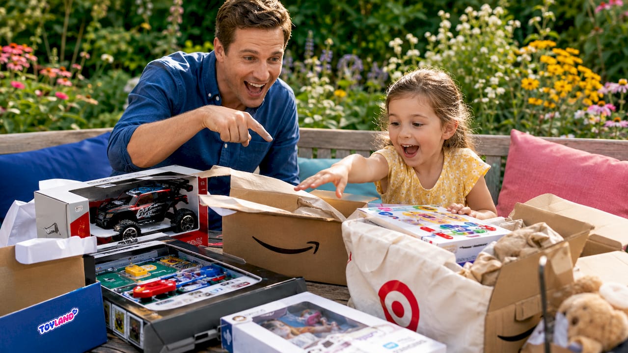 Father and daughter exploring popular marketplace toys at kitchen table