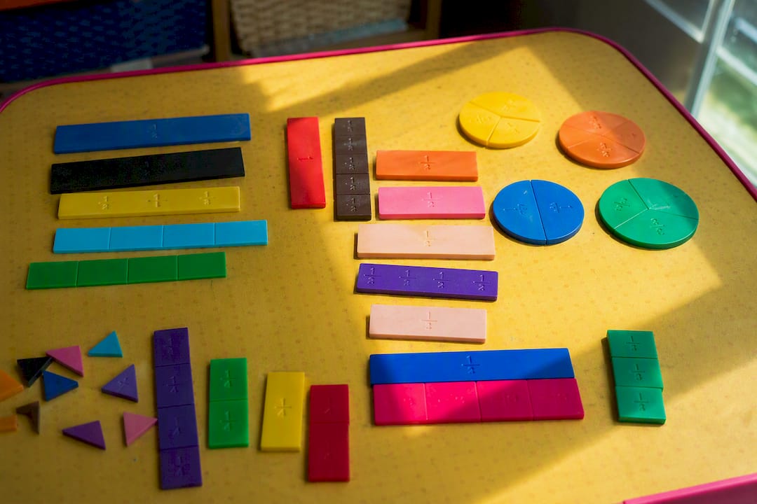 Fraction tiles and bars arranged on table