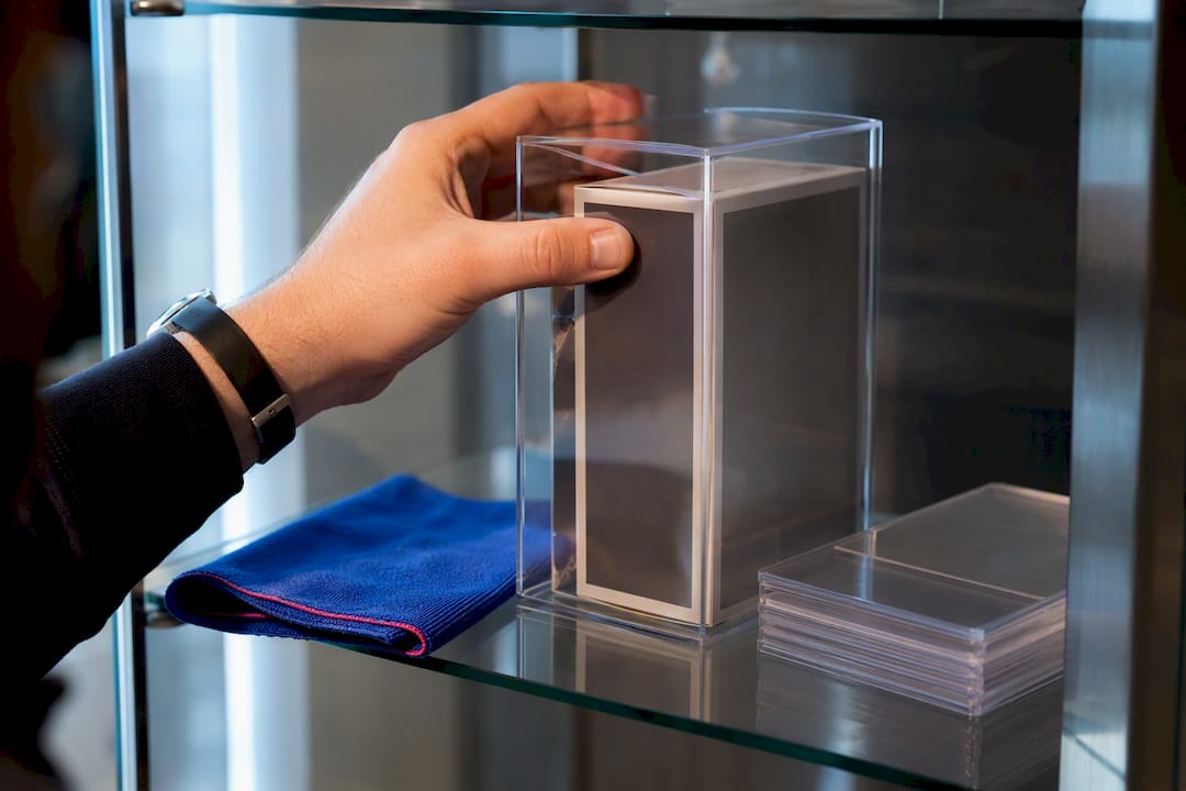 Collector placing boxed figure in case