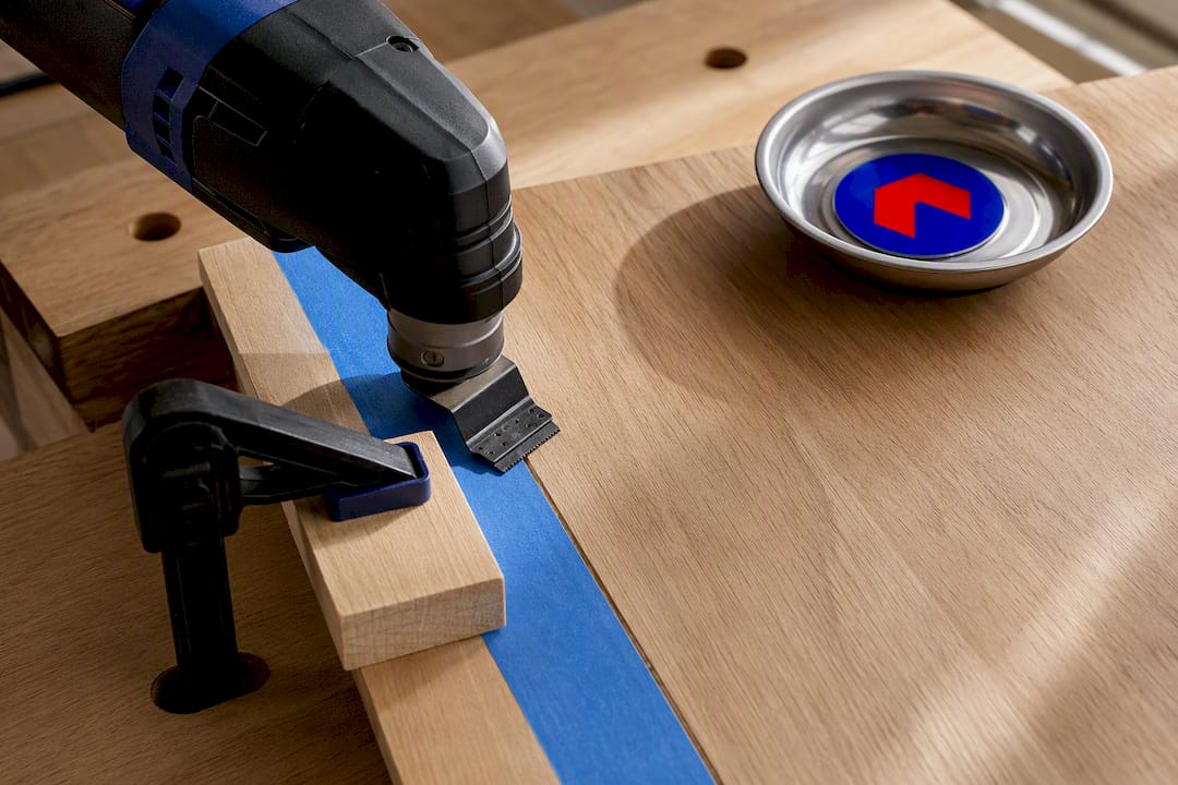 Taped wood cut guided by an oscillating tool