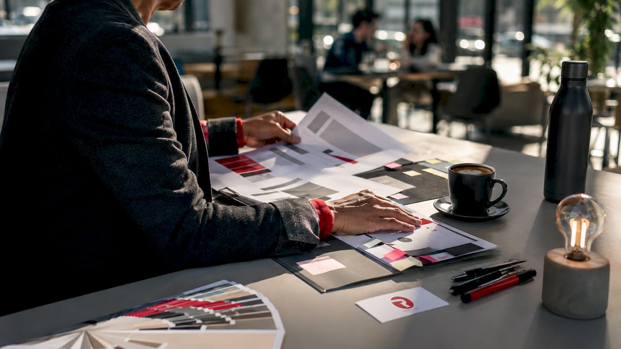 Hands arranging localisation templates on desk