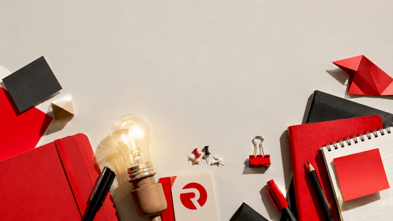 Top-down flat-lay of workspace with lightbulb and Radka colors