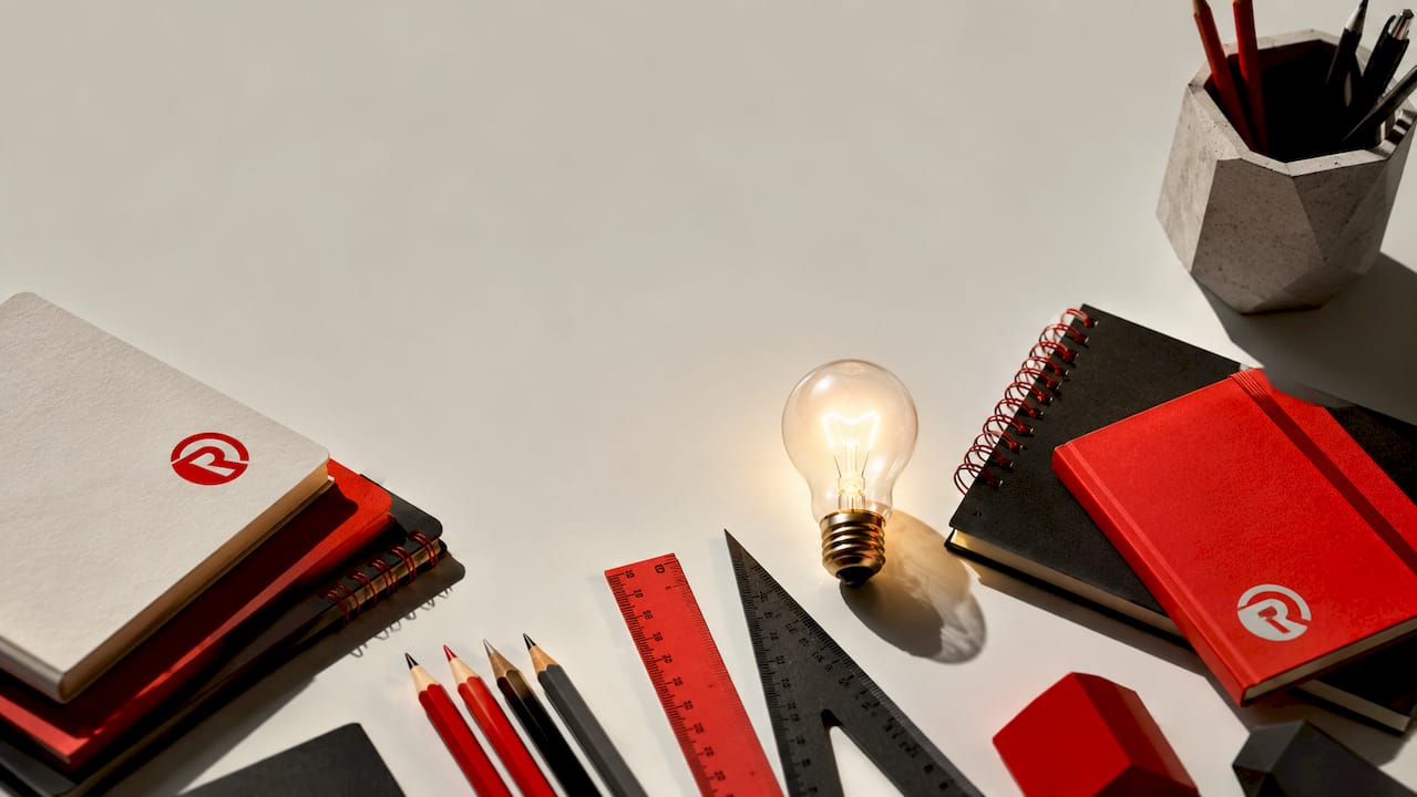 Creative office supplies and glowing bulb flat lay