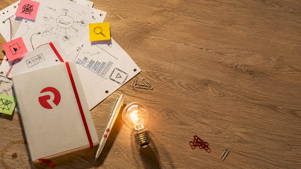 Overhead flat-lay of marketing planning materials with lightbulb