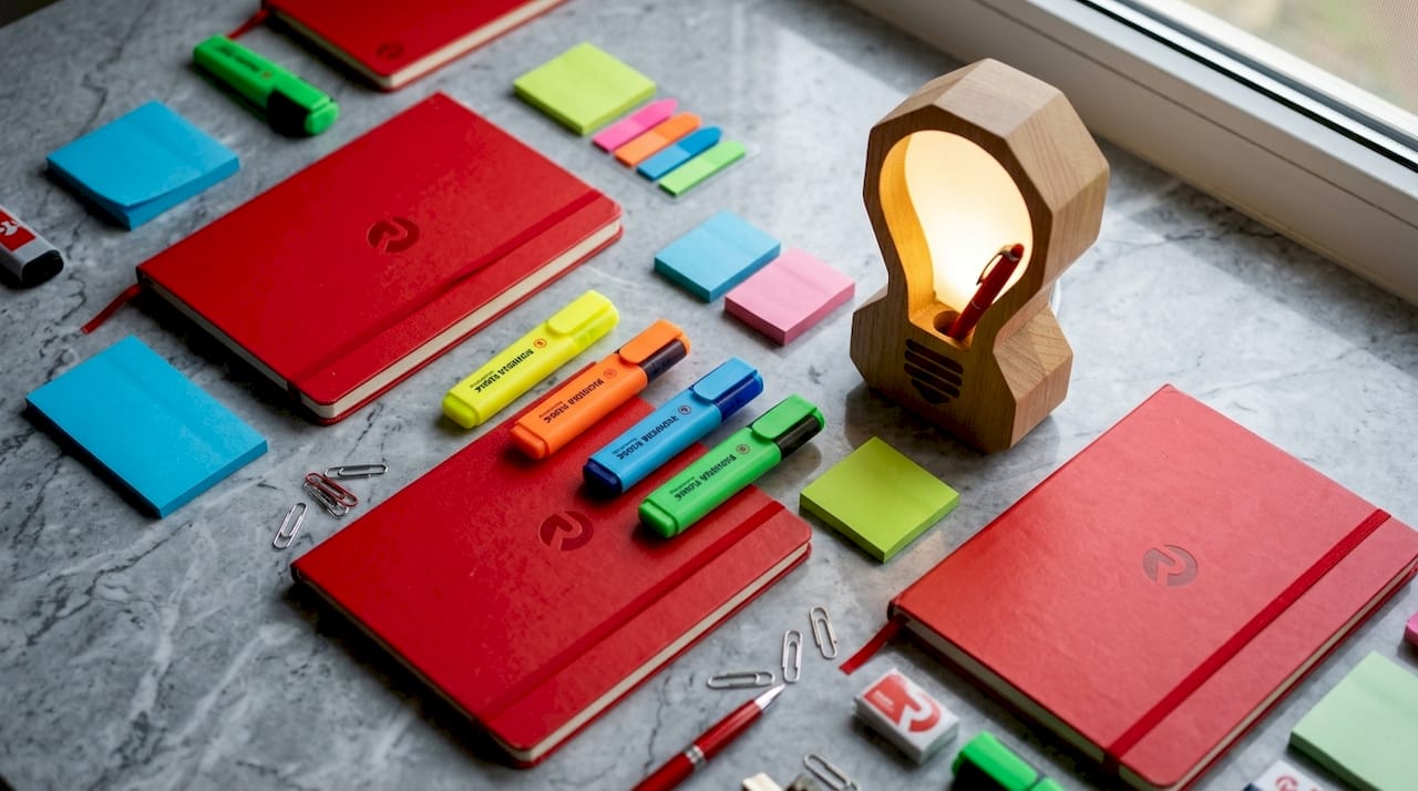 Creative agency flat-lay with branded stationery and glowing lightbulb