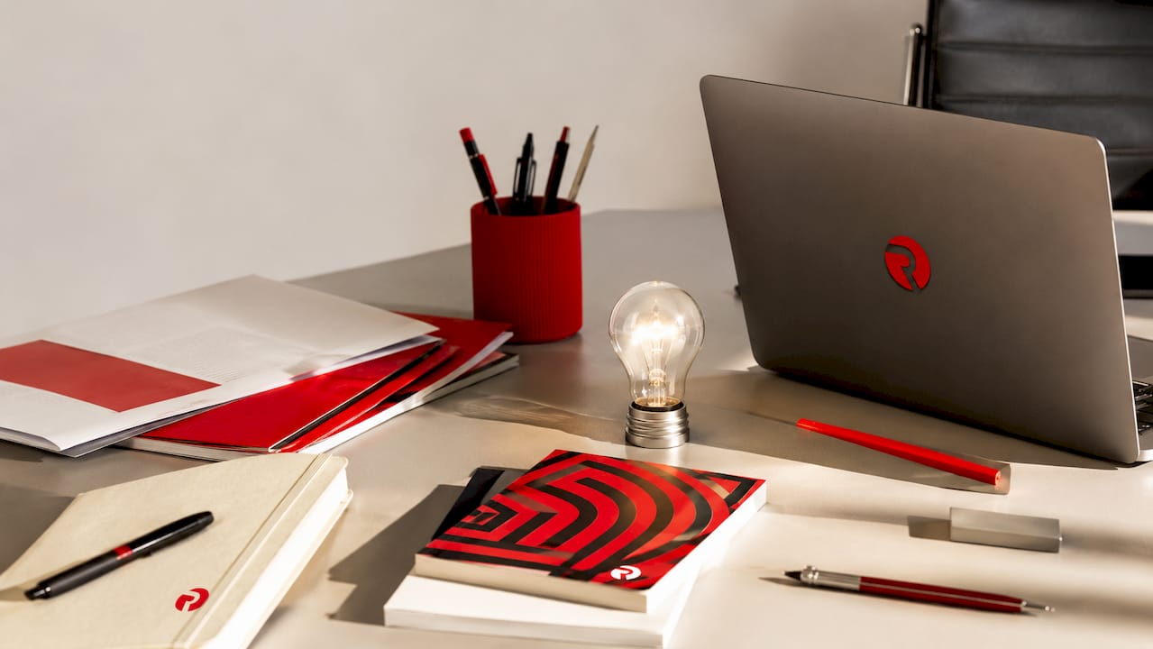 Overhead flat-lay of branded stationery with lightbulb motif