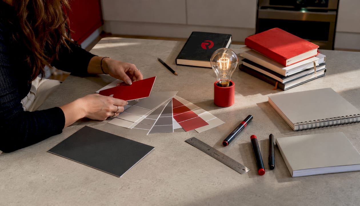 Close-up of hands arranging Radkaadvertising design tools