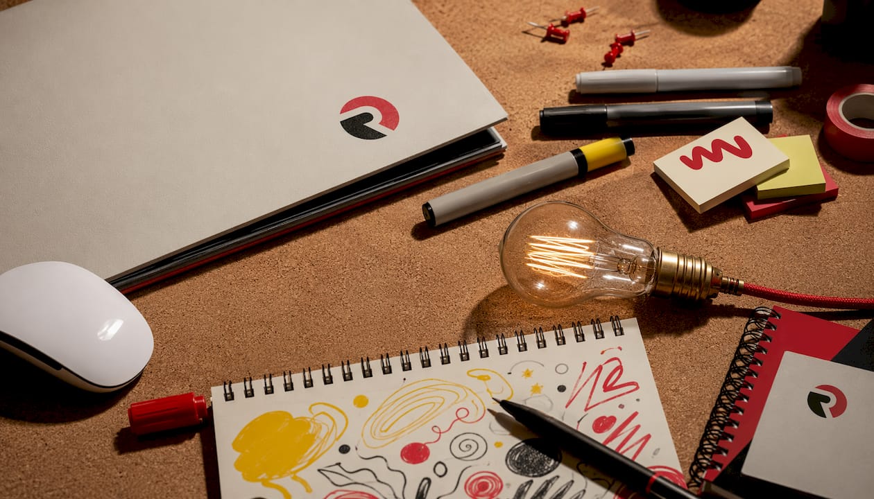 Flat-lay of branded supplies and glowing bulb