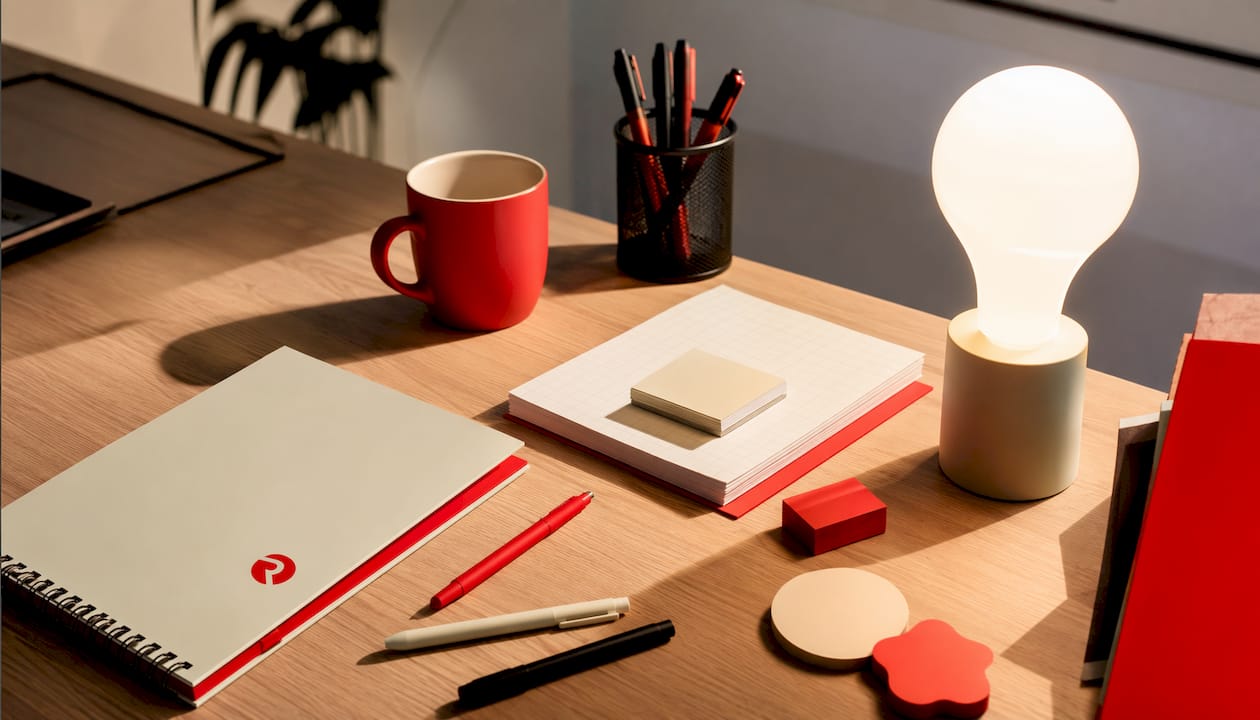 Overhead flat-lay of creative workspace with lightbulb lamp