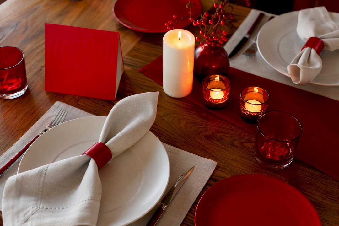 Festive table setting with glowing bulb and branded colours