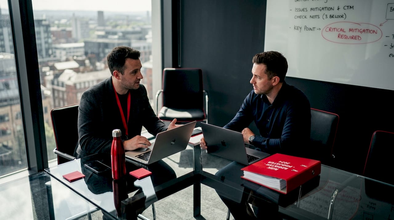 Two IT managers meeting about risk documentation