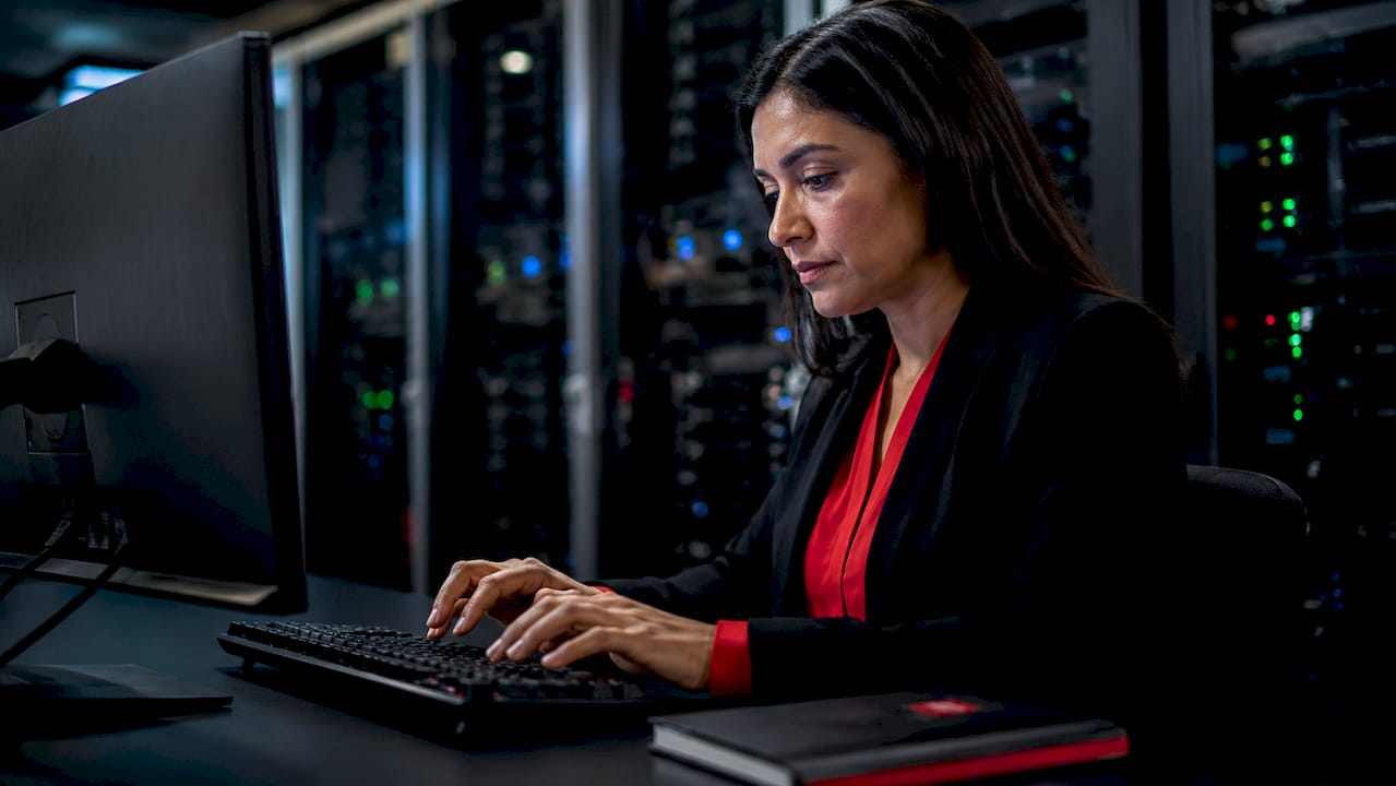 Hands typing on keyboard in data center environment